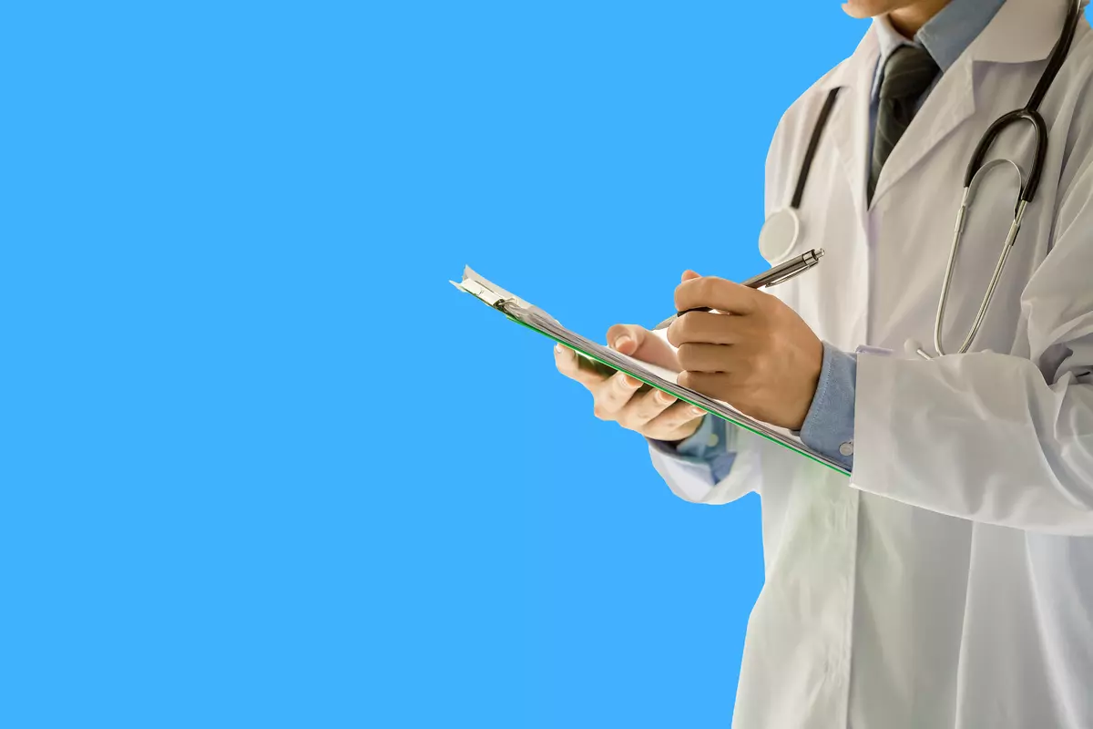 Doctor Writing on Clipboard - Men's Health Clinic